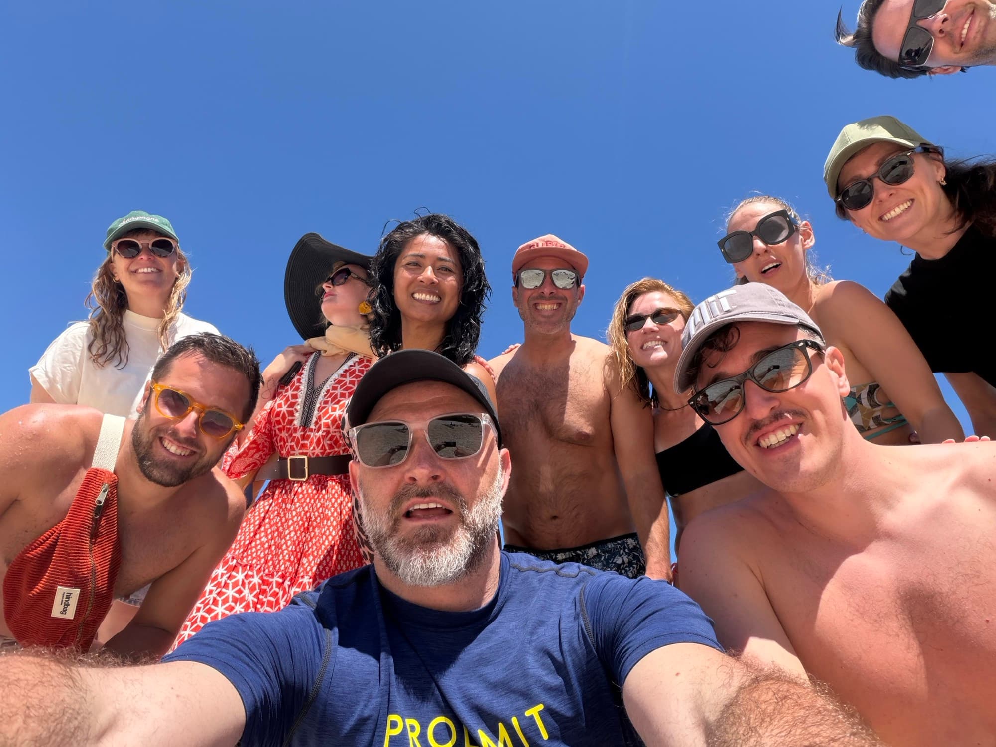 Feel.Travel friends in a circle under blue sky
