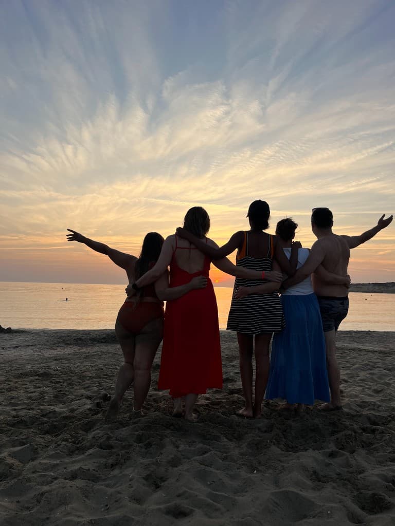 Friends at the beach at sunset